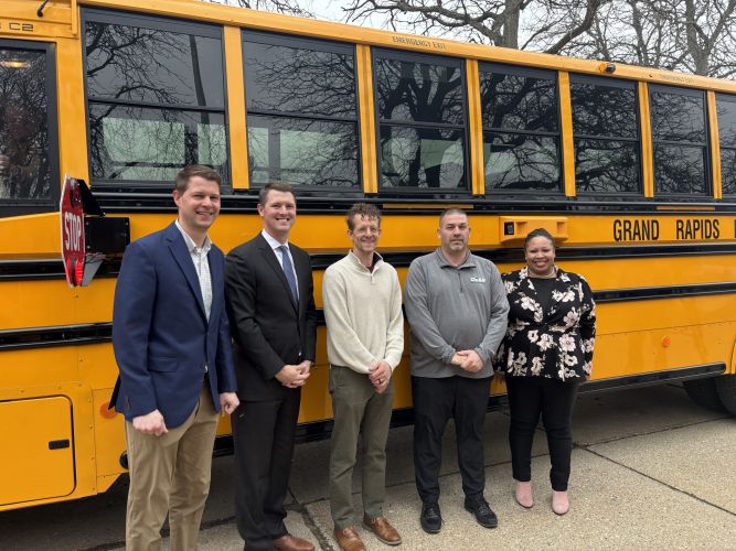 Dean employees in front of school bus