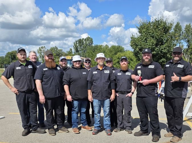 Photo of the team that won the annual bus pull competition