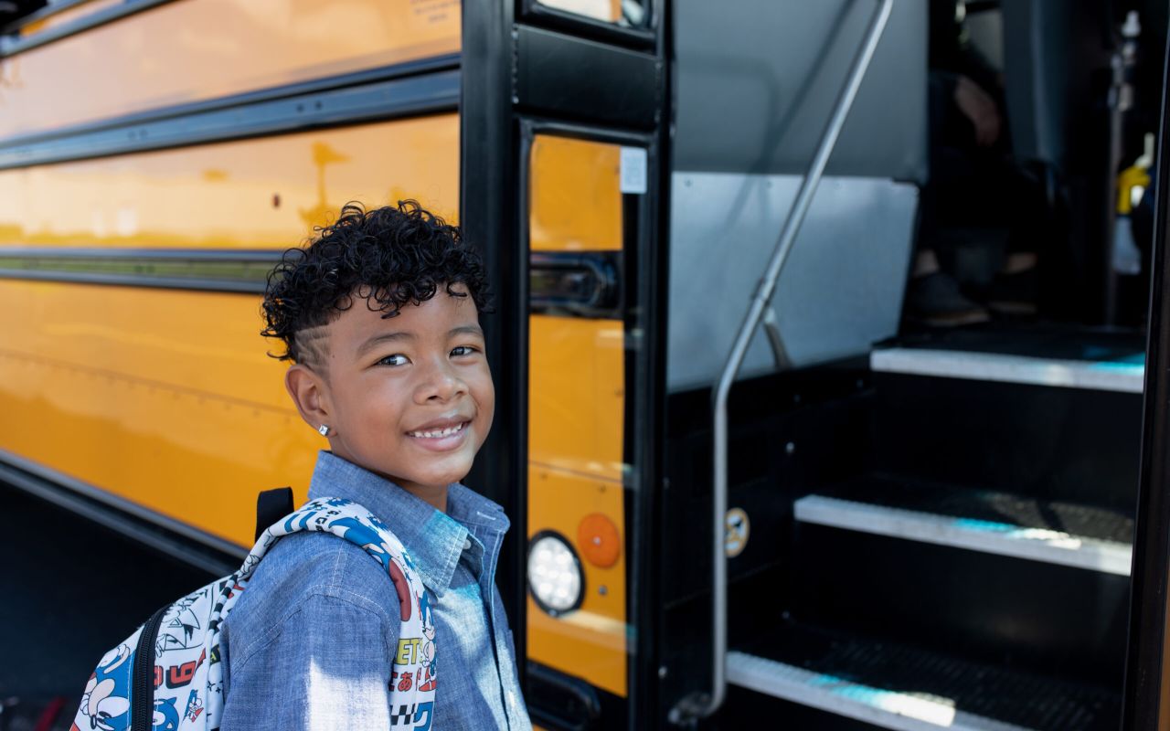 boy getting on bus